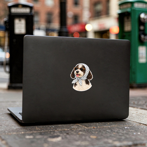 Black laptop with a dog sticker on a city street background